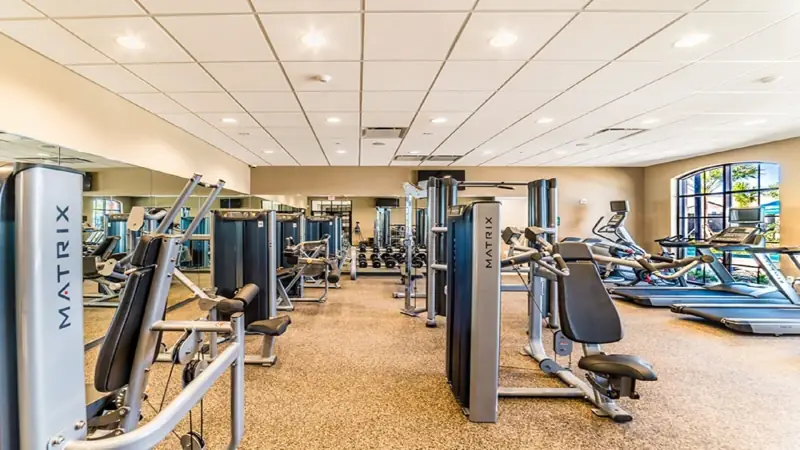 Fitness facility – A gym with various exercise equipment, including treadmills and weight machines, arranged in a spacious layout.