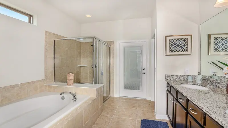 down stairs master bath – A modern bathroom with a glass-enclosed shower, a freestanding bathtub, and a vanity with a sink and countertop.