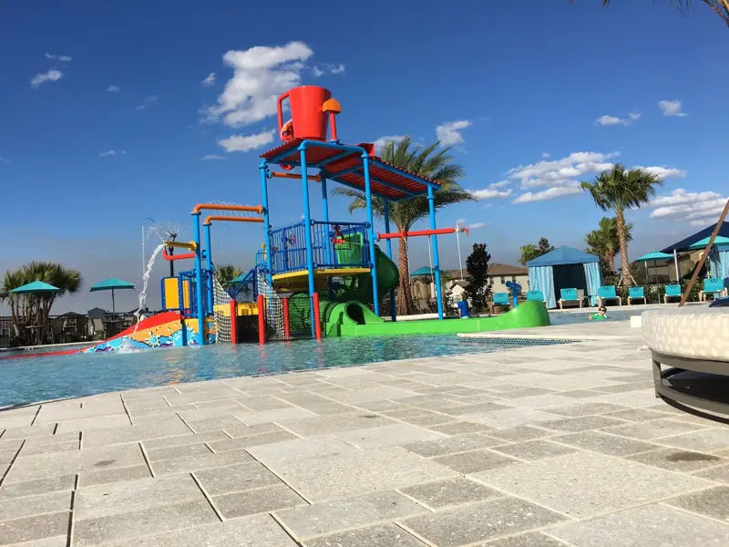 AquaPark-Knee deep for the younger children – A water park with a pool, slides, and a play structure.